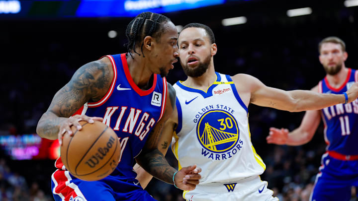 Feb 21, 2025; Sacramento, California, USA; Sacramento Kings forward DeMar DeRozan (10) dribbles the ball against Golden State Warriors guard Stephen Curry (30) during the second quarter at Golden 1 Center. Mandatory Credit: Sergio Estrada-Imagn Images