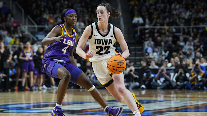 Apr 1, 2024; Albany, NY, USA; Iowa Hawkeyes guard Caitlin Clark (22) controls the ball against LSU Lady Tigers guard Flau'jae Johnson (4) in the fourth quarter in the finals of the Albany Regional in the 2024 NCAA Tournament at MVP Arena. Mandatory Credit: Gregory Fisher-Imagn Images