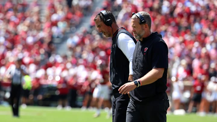 Sep 13, 2025; Tuscaloosa, Alabama, USA; Wisconsin Badgers head coach Luke Fickell converses with an assistant during the second quarter against the Alabama Crimson Tide at Saban Field at Bryant-Denny Stadium. Mandatory Credit: David Leong-Imagn Images
