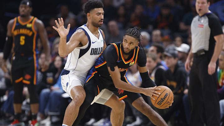 Nov 17, 2024; Oklahoma City, Oklahoma, USA; Dallas Mavericks guard Quentin Grimes (5) defends a drive by Oklahoma City Thunder guard Isaiah Joe (11) during the second quarter at Paycom Center. Mandatory Credit: Alonzo Adams-Imagn Images