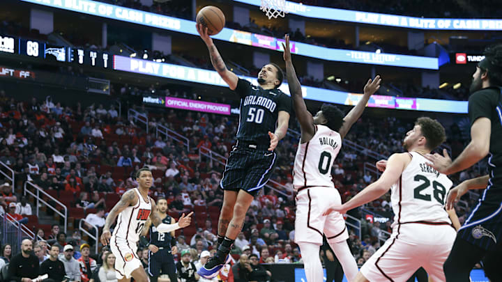 Orlando Magic guard Cole Anthony (50) attempts to score a basket as Houston Rockets guard Aaron Holiday (0) defends during the fourth quarter at Toyota Center. Orlando Magic guard Cole Anthony (50) attempts to score a basket as Houston Rockets guard Aaron Holiday (0) defends during the fourth quarter at Toyota Center.