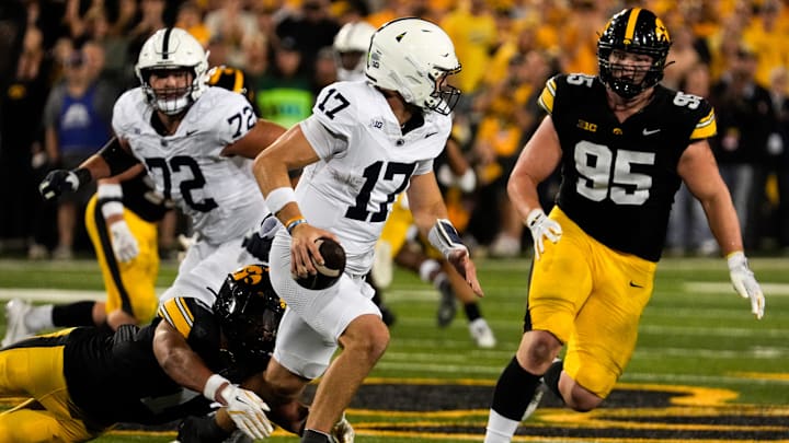 Penn State Nittany Lions quarterback Ethan Grunkemeyer (17) scrambles away from Iowa Hawkeyes defensive back Xavier Nwankpa (1) and Iowa Hawkeyes defensive lineman Aaron Graves (95). Penn State Nittany Lions quarterback Ethan Grunkemeyer (17) scrambles away from Iowa Hawkeyes defensive back Xavier Nwankpa (1) and Iowa Hawkeyes defensive lineman Aaron Graves (95).