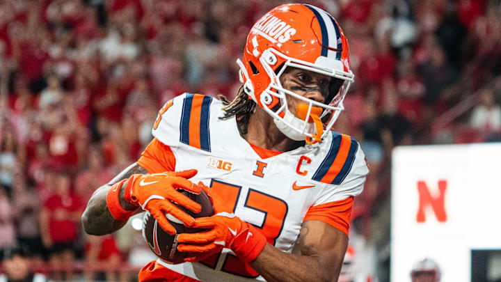 Sep 20, 2024; Lincoln, Nebraska, USA; Illinois Fighting Illini wide receiver Pat Bryant (13) scores a touchdown in overtime against the Nebraska Cornhuskers at Memorial Stadium. Mandatory Credit: Dylan Widger-Imagn Images