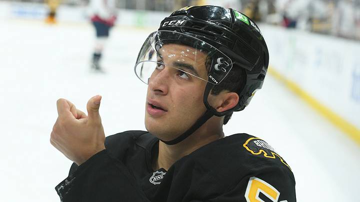 Sep 21, 2025; Boston, Massachusetts, USA; Boston Bruins center Matthew Poitras (51) shows the official blood from his mouth after getting hit in the mouth during the third period against the Washington Capitals at TD Garden. Mandatory Credit: Bob DeChiara-Imagn Images