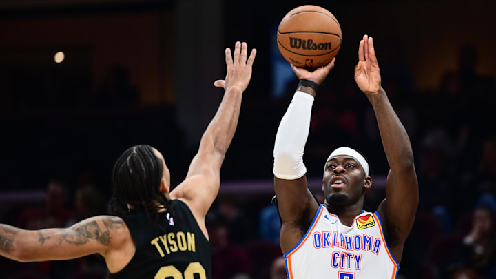 Jan 19, 2026; Cleveland, Ohio, USA; Oklahoma City Thunder guard Luguentz Dort (5) shoots over the defense of Cleveland Cavaliers guard Jaylon Tyson (20) during the first half at Rocket Arena. Mandatory Credit: Ken Blaze-Imagn Images