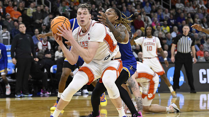 Mar 20, 2025; Providence, RI, USA; Clemson Tigers center Viktor Lakhin (0) loses control of the ball against McNeese State Cowboys forward Christian Shumate (24) during the first half at Amica Mutual Pavilion. Mandatory Credit: Eric Canha-Imagn Images