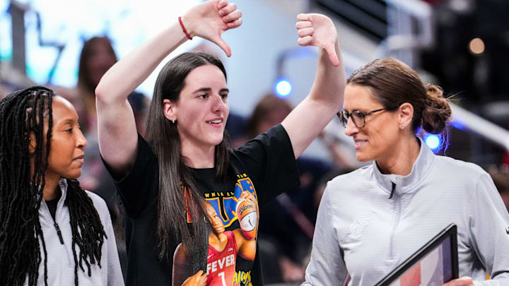 Indiana Fever guard Caitlin Clark (22) jokes with Indiana Fever head coach Stephanie White on Saturday, Aug. 9, 2025, during a game between the Indiana Fever and the Chicago Sky at Gainbridge Fieldhouse in Indianapolis.