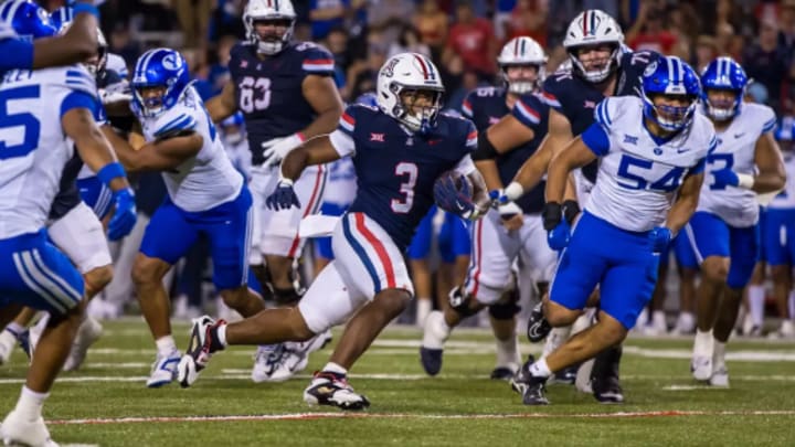 Kedrick Reescano bursts through a gap created by the offensive line against BYU Kedrick Reescano bursts through a gap created by the offensive line against BYU