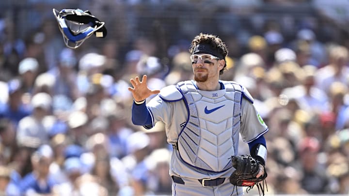 Apr 21, 2024; San Diego, California, USA; Toronto Blue Jays catcher Danny Jansen (9) catches his mask during the sixth inning against the San Diego Padres at Petco Park. Mandatory Credit: Orlando Ramirez-Imagn Images