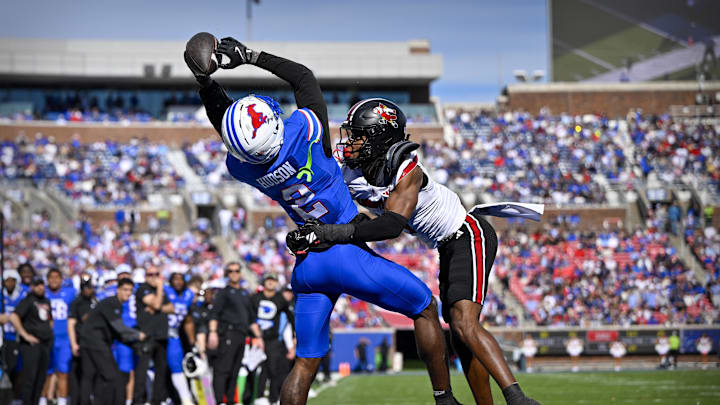 Nov 22, 2025; Dallas, Texas, USA; SMU Mustangs wide receiver Jordan Hudson (2) catches a pass for a touchdown over Louisville Cardinals defensive back Jabari Mack (4) during the first half at Gerald J. Ford Stadium. Mandatory Credit: Jerome Miron-Imagn Images