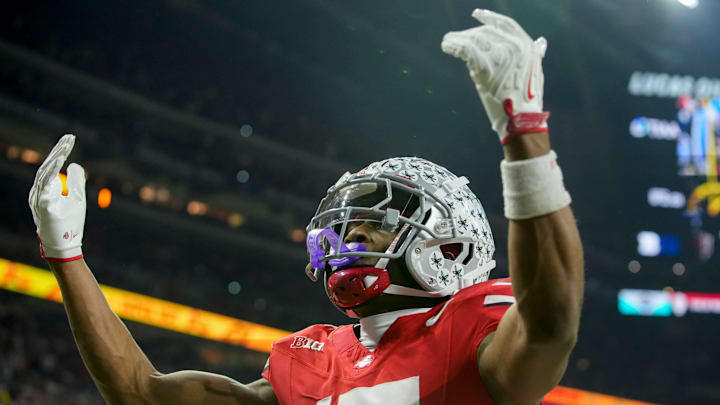 Ohio State Buckeyes wide receiver Carnell Tate (17) celebrates a touchdown Saturday, Dec. 6, 2025, during the Big Ten football championship against the Indiana Hoosiers at Lucas Oil Stadium in Indianapolis.