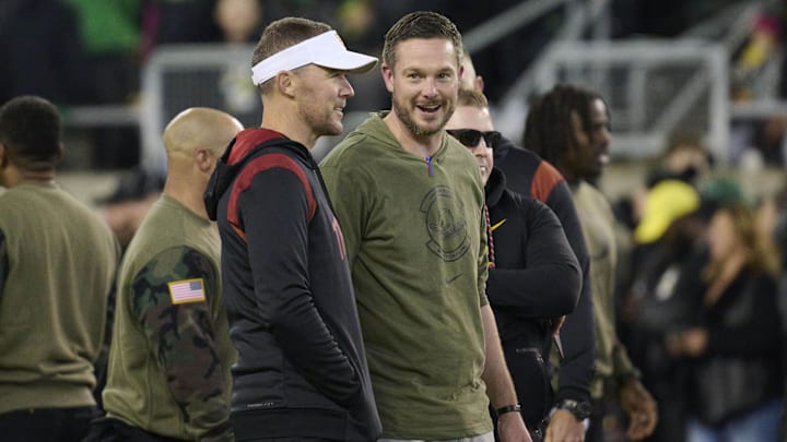 Nov 11, 2023; Eugene, Oregon, USA; USC Trojans head coach Lincoln Riley, left, and Oregon Ducks head coach Dan Lanning talk before a game at Autzen Stadium. Mandatory Credit: Troy Wayrynen-Imagn Images