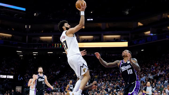 Dec 16, 2024; Sacramento, California, USA; Denver Nuggets guard Jamal Murray (27) shoots the ball against Sacramento Kings forward DeMar DeRozan (10) during the second quarter at Golden 1 Center. Mandatory Credit: Sergio Estrada-Imagn Images