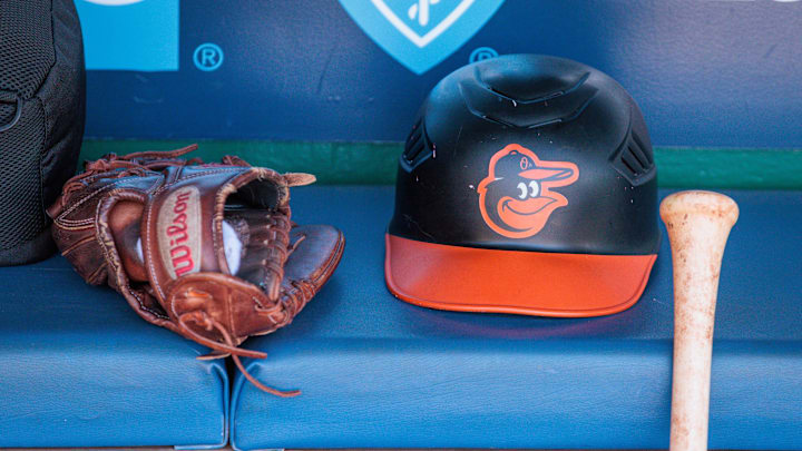 Apr 21, 2024; Kansas City, Missouri, USA; Baltimore Orioles hat and glove sits in the dugout during the ninth inning against the Kansas City Royals at Kauffman Stadium. 