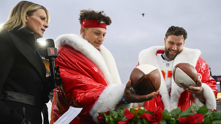 Kansas City Chiefs quarterback Patrick Mahomes and tight end Travis Kelce look at  football cakes while being interviewed by Netflix reporter Stacey Dales.