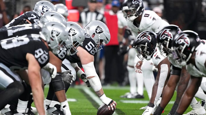 Dec 16, 2024; Paradise, Nevada, USA; Helmets at the line of scrimmage as Las Vegas Raiders guard Jackson Powers-Johnson (58) snaps the ball against the Atlanta Falcons in the first half at Allegiant Stadium. Mandatory Credit: Kirby Lee-Imagn Images Dec 16, 2024; Paradise, Nevada, USA; Helmets at the line of scrimmage as Las Vegas Raiders guard Jackson Powers-Johnson (58) snaps the ball against the Atlanta Falcons in the first half at Allegiant Stadium. Mandatory Credit: Kirby Lee-Imagn Images