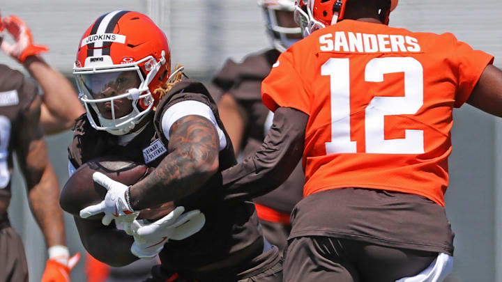 Cleveland Browns running back Quinshon Judkins (10) takes a handoff from quarterback Shedeur Sanders (12) during NFL rookie minicamp at the Cleveland Browns training facility on Friday, May 9, 2025, in Berea, Ohio.