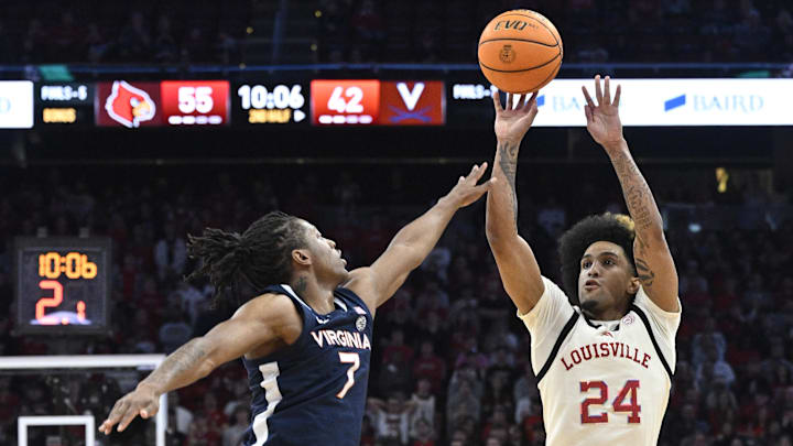 Jan 18, 2025; Louisville, Kentucky, USA; Louisville Cardinals guard Chucky Hepburn (24) shoots against Virginia Cavaliers guard Dai Dai Ames (7) during the second half at KFC Yum! Center. Louisville defeated Virginia 81-67. Mandatory Credit: Jamie Rhodes-Imagn Images