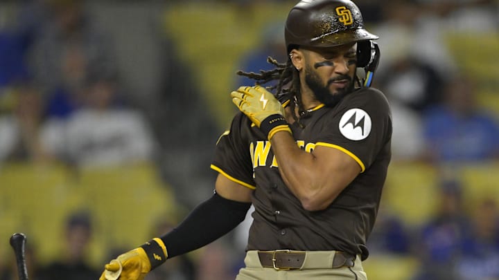 Jun 19, 2025; Los Angeles, California, USA;   San Diego Padres right fielder Fernando Tatis Jr. (23) reacts as he is hit by a pitch in the eighth inning against the Los Angeles Dodgers at Dodger Stadium. Mandatory Credit: Jayne Kamin-Oncea-Imagn Images