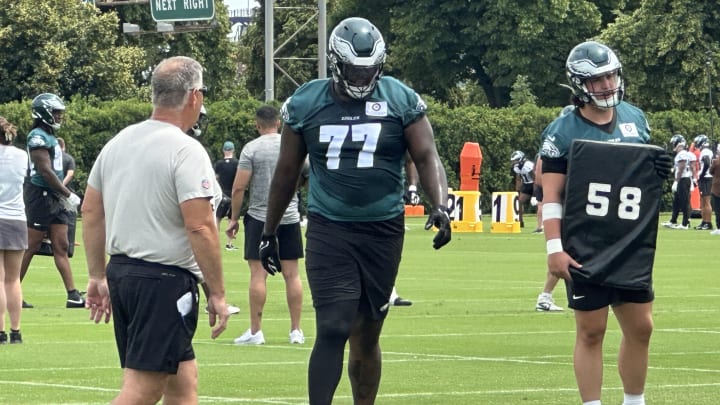 Mekhi Becton (No. 77) gets some technique tips from line coach Jeff Stoutland as Becton transitions to guard during the Philadelphia Eagles mandatory minicamp.