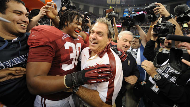Alabama Crimson Tide head coach Nick Saban (right) hugs linebacker Dont'a Hightower (30) after the 2012 BCS National Championship game.