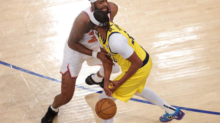 May 29, 2025; New York, New York, USA: Indiana Pacers center Myles Turner (33) loses control of the ball against New York Knicks center Mitchell Robinson (23) in the third quarter during game five of the eastern conference finals for the 2025 NBA Playoffs at Madison Square Garden. Mandatory Credit: Brad Penner-Imagn Images