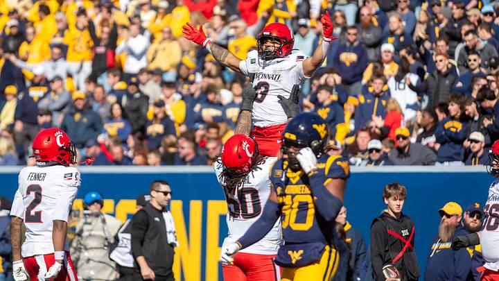 Oct 17, 2026; Morgantown, West Virginia, USA; Cincinnati Bearcats running back Cole Tabb (3) celebrates with offensive lineman Evan Tengesdahl (50) after a touchdown during the fourth quarter against the West Virginia Mountaineers at Milan Puskar Stadium. Mandatory Credit: Ben Queen-Imagn Images Oct 17, 2026; Morgantown, West Virginia, USA; Cincinnati Bearcats running back Cole Tabb (3) celebrates with offensive lineman Evan Tengesdahl (50) after a touchdown during the fourth quarter against the West Virginia Mountaineers at Milan Puskar Stadium. Mandatory Credit: Ben Queen-Imagn Images