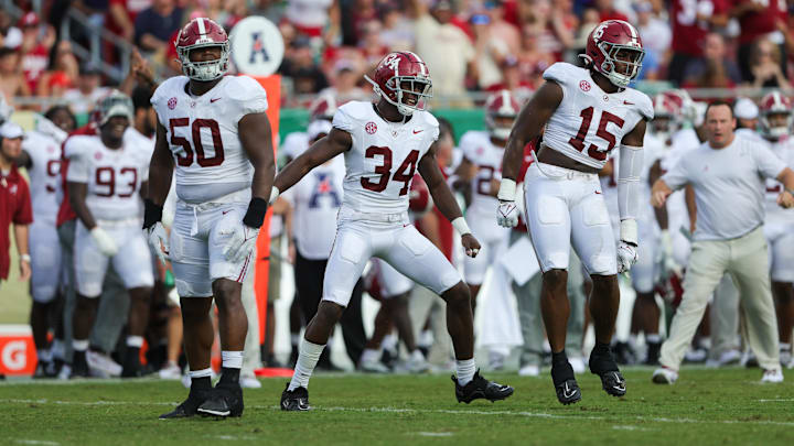 Sep 16, 2023; Tampa, Florida, USA;  Alabama Crimson Tide linebacker Dallas Turner (15) Alabama Crimson Tide linebacker Quandarrius Robinson (34) and Alabama Crimson Tide defensive lineman Tim Smith (50) celebrate after forcing a turnover against the South Florida Bulls in the second quarter at Raymond James Stadium. Mandatory Credit: Nathan Ray Seebeck-USA TODAY Sports