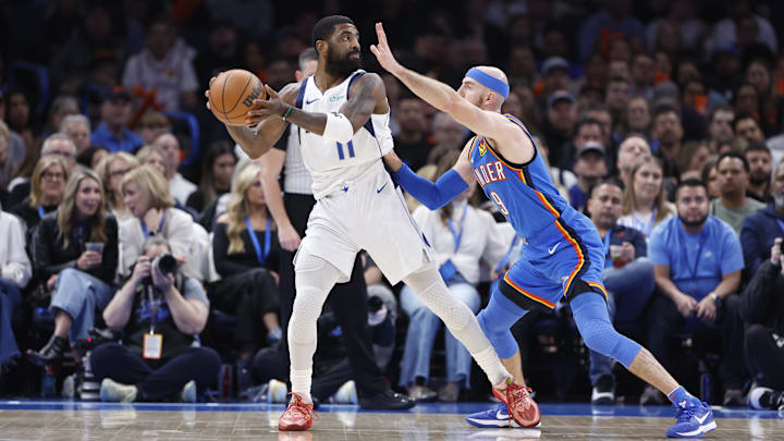 Jan 23, 2025; Oklahoma City, Oklahoma, USA; Oklahoma City Thunder guard Alex Caruso (9) defends Dallas Mavericks guard Kyrie Irving (11) as he passes during the second half at Paycom Center. Mandatory Credit: Alonzo Adams-Imagn Images Jan 23, 2025; Oklahoma City, Oklahoma, USA; Oklahoma City Thunder guard Alex Caruso (9) defends Dallas Mavericks guard Kyrie Irving (11) as he passes during the second half at Paycom Center. Mandatory Credit: Alonzo Adams-Imagn Images