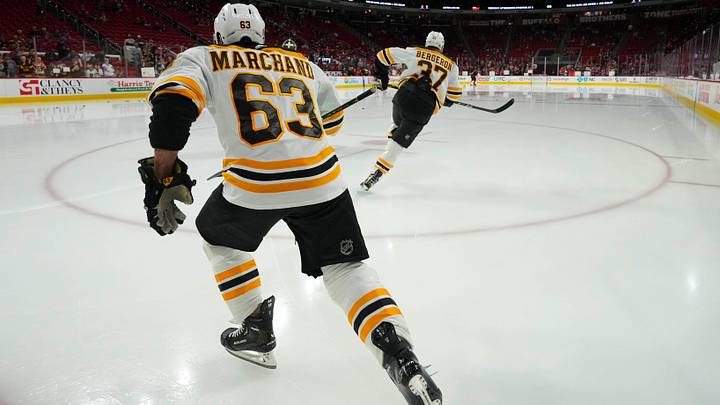 Jan 29, 2023; Raleigh, North Carolina, USA;  Boston Bruins left wing Brad Marchand (63) and center Patrice Bergeron (37) skate out onto the ice before the game against the Carolina Hurricanes at PNC Arena. Mandatory Credit: James Guillory-USA TODAY Sports