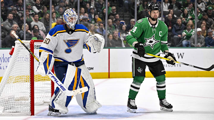 Dec 14, 2024; Dallas, Texas, USA; Dallas Stars left wing Jamie Benn (14) screens St. Louis Blues goaltender Jordan Binnington (50) during the second period at American Airlines Center. Mandatory Credit: Jerome Miron-Imagn Images