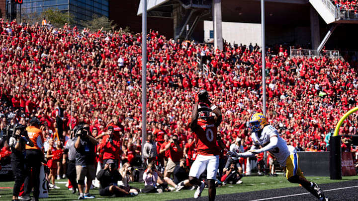 Cincinnati Bearcats wide receiver Tony Johnson (0) scores a touchdown as Pittsburgh Panthers defensive back Rashad Battle (15) in the first quarter of the College Football game at Nippert Stadium in Cincinnati on Saturday, Sept. 7, 2024.