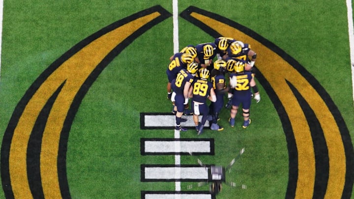 Jan 8, 2024; Houston, TX, USA; The Michigan Wolverines huddle on offense during the second quarter against the Washington Huskies in the 2024 College Football Playoff national championship game at NRG Stadium. Mandatory Credit: James Lang-Imagn Images Jan 8, 2024; Houston, TX, USA; The Michigan Wolverines huddle on offense during the second quarter against the Washington Huskies in the 2024 College Football Playoff national championship game at NRG Stadium. Mandatory Credit: James Lang-Imagn Images