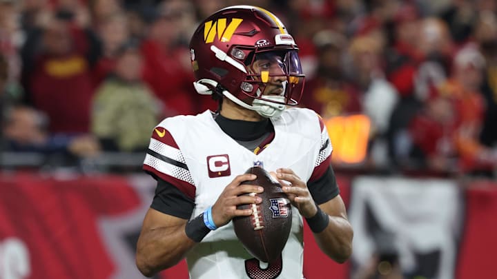 Jan 12, 2025; Tampa, Florida, USA; Washington Commanders quarterback Jayden Daniels (5) drops to throw during the second quarter of a NFC wild card playoff against the Tampa Bay Buccaneers at Raymond James Stadium. Mandatory Credit: Kim Klement Neitzel-Imagn Images