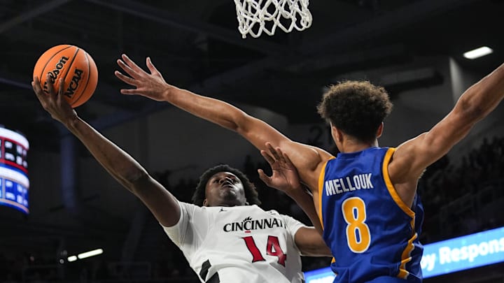 Bearcats Tyler Betsey (14) leaps in the air with the ball during their game against the Morehead State Eagles at Fifth Third Arena on Friday November 8, 2024. Bearcats lead the game at halftime with a score of 37-19. Bearcats Tyler Betsey (14) leaps in the air with the ball during their game against the Morehead State Eagles at Fifth Third Arena on Friday November 8, 2024. Bearcats lead the game at halftime with a score of 37-19.