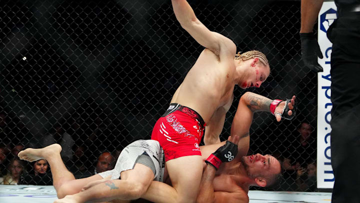 Dec 16, 2023; Las Vegas, Nevada, USA; Tony Ferguson (red gloves) fights Paddy Pimblett (blue gloves)