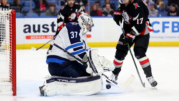Dec 5, 2024; Buffalo, New York, USA;  Winnipeg Jets goaltender Connor Hellebuyck (37) makes a save on Buffalo Sabres left wing Jason Zucker (17) during the second period at KeyBank Center. Mandatory Credit: Timothy T. Ludwig-Imagn Images