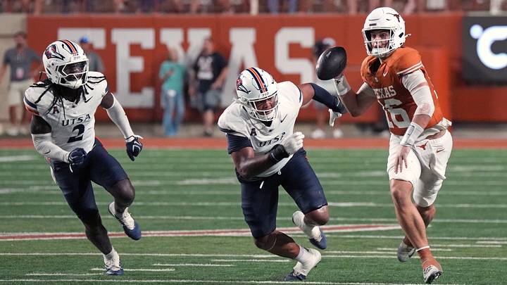 Texas Longhorns quarterback Arch Manning looks to pass the ball while defended by by UTSA Roadrunners defensive lineman Jeremiah Bailey and linebacker Owen Pewee Texas Longhorns quarterback Arch Manning looks to pass the ball while defended by by UTSA Roadrunners defensive lineman Jeremiah Bailey and linebacker Owen Pewee