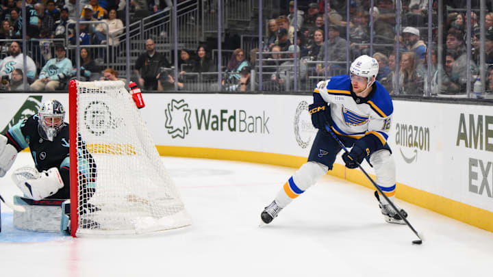 Apr 12, 2025; Seattle, Washington, USA; St. Louis Blues center Radek Faksa (12) plays the puck during the third period against the Seattle Kraken at Climate Pledge Arena. Mandatory Credit: Steven Bisig-Imagn Images