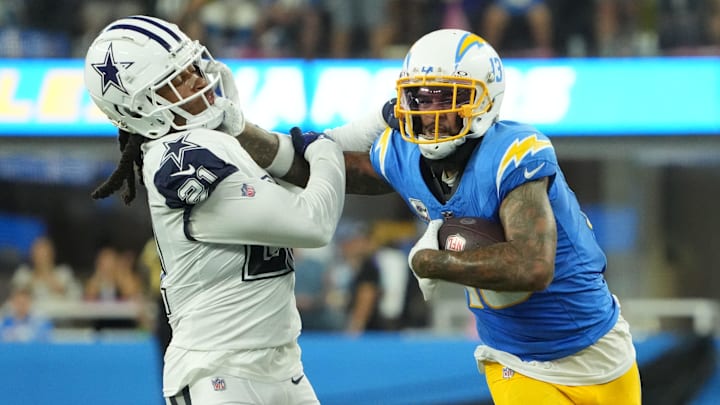 Keenan Allen stiff-arms to get yards after the catch against Dallas. Nothing can be assumed about his futuer in Chicago but more could be known after the draft.
