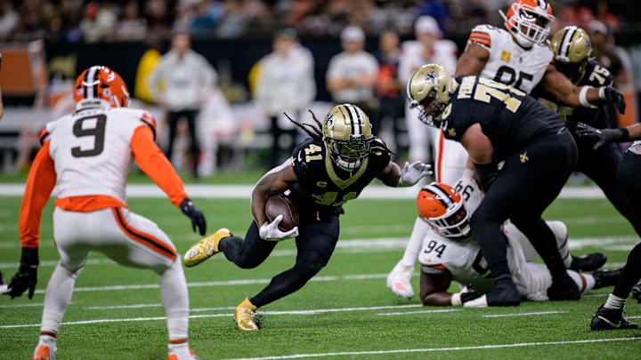Nov 17, 2024; New Orleans, Louisiana, USA; New Orleans Saints running back Alvin Kamara (41) runs against Cleveland Browns safety Grant Delpit (9) and defensive tackle Dalvin Tomlinson (94) during the second quarter at Caesars Superdome. Mandatory Credit: Matthew Hinton-Imagn Images