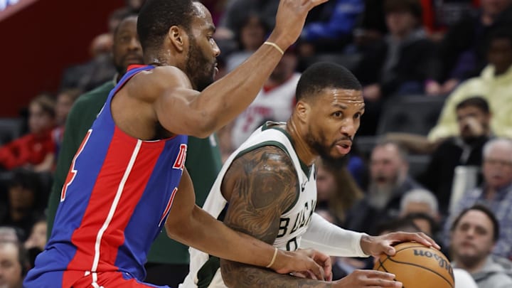 Jan 20, 2024; Detroit, Michigan, USA;  Milwaukee Bucks guard Damian Lillard (0) dribbles on Detroit Pistons guard Alec Burks (14) in the second half at Little Caesars Arena. Mandatory Credit: Rick Osentoski-Imagn Images
