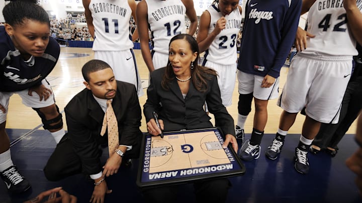 Nov 16, 2010; Washington, DC, USA; Georgetown Hoyas head coach Terri Williams-Flournoy (center) and assistant coach Cory McNeill (left) give out instructions during a time out against the Maryland Terrapins during the second half at McDonough Arena.  Mandatory Credit: Rafael Suanes-USA TODAY Sports