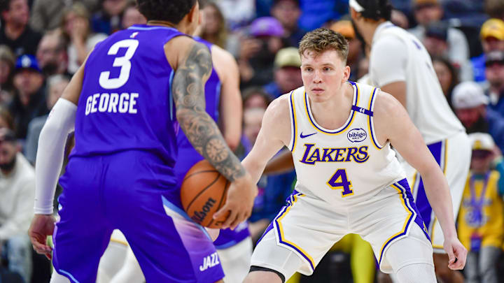 Dec 1, 2024; Salt Lake City, Utah, USA; Los Angeles Lakers forward Dalton Knecht (4) defends Utah Jazz guard Keyonte George (3) during the second half at the Delta Center. Mandatory Credit: Christopher Creveling-Imagn Images