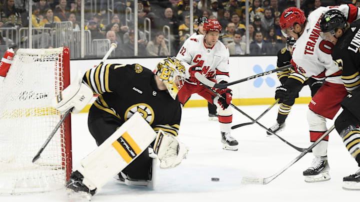 Apr 9, 2024; Boston, Massachusetts, USA; Carolina Hurricanes left wing Teuvo Teravainen (86) looks for a loose puck in front of Boston Bruins goaltender Jeremy Swayman (1) during the second period at TD Garden. Mandatory Credit: Bob DeChiara-Imagn Images