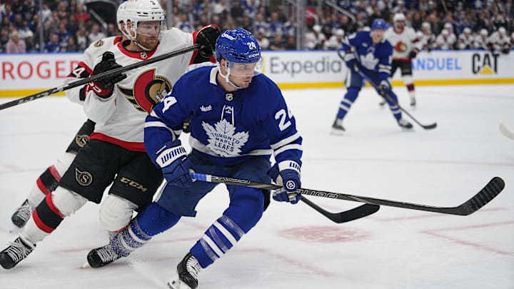 Apr 20, 2025; Toronto, Ontario, CAN; Toronto Maple Leafs forward Scott Laughton (24)and Ottawa Senators defenseman Nick Jensen (3) battle for position during the first period of game one of the first round of the 2025 Stanley Cup Playoffs at Scotiabank Arena. Mandatory Credit: John E. Sokolowski-Imagn Images