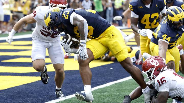 Michigan Wolverines running back Jordan Marshall carries the ball for a touchdown defended by Oklahoma Sooners defensive line Michigan Wolverines running back Jordan Marshall carries the ball for a touchdown defended by Oklahoma Sooners defensive line