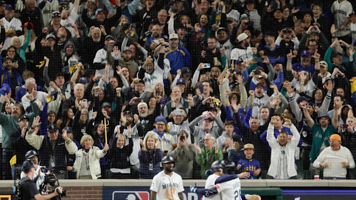 Oct 17, 2025; Seattle, Washington, USA; Fans react as Seattle Mariners third baseman Eugenio Suarez (28) celebrates after hitting a grand slam against the Toronto Blue Jays in the eighth inning during game five of the ALCS round for the 2025 MLB playoffs at T-Mobile Park. Mandatory Credit: John Froschauer-Imagn Images