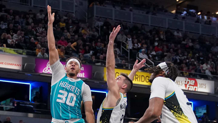 Dec 8, 2024; Indianapolis, Indiana, USA; Charlotte Hornets guard Seth Curry (30) attempts a shot against Indiana Pacers guard T.J. McConnell (9) during the second half at Gainbridge Fieldhouse. Mandatory Credit: Robert Goddin-Imagn Images 