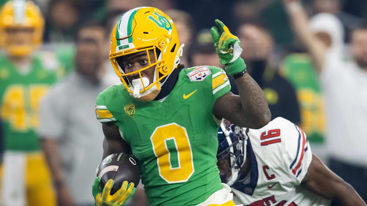 Jan 1, 2024; Glendale, AZ, USA; Oregon Ducks running back Bucky Irving (0) against the Liberty